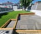 Company/TP logo - "Greener Lawn Artificial Grass"
