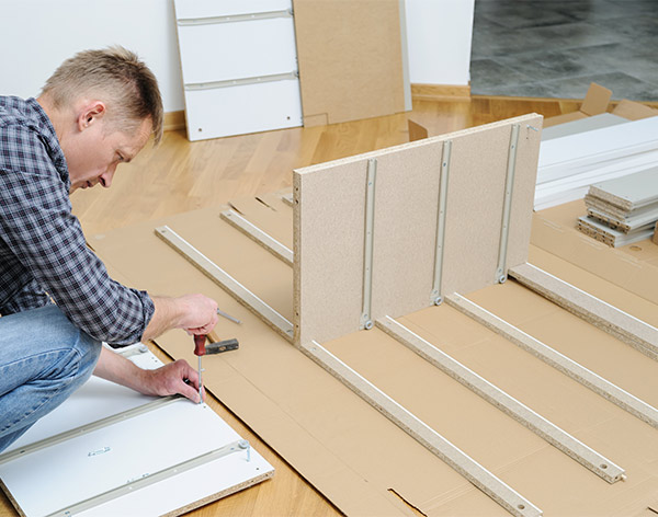  handyman assembling storage unit