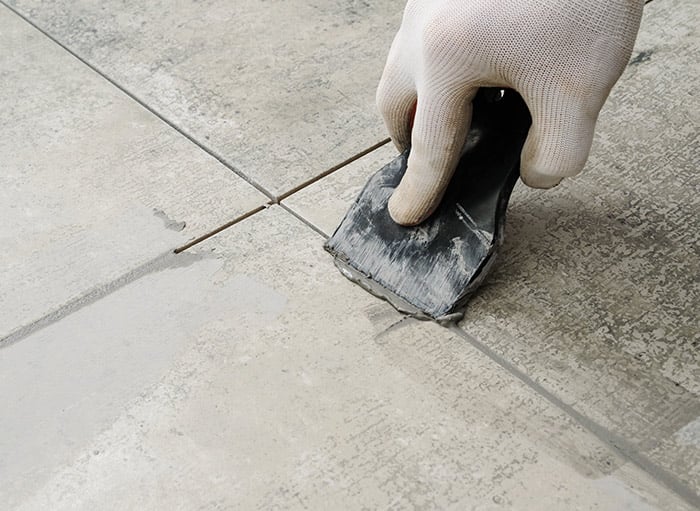 Grouting newly laid tiles