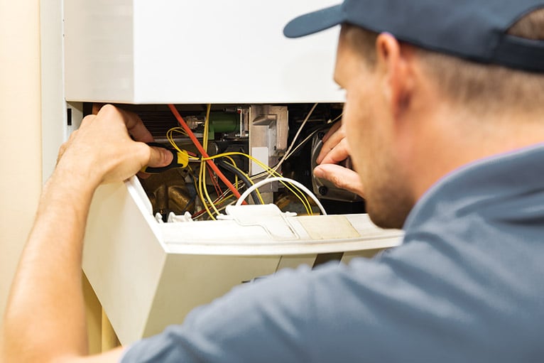 Plumber repairing boiler