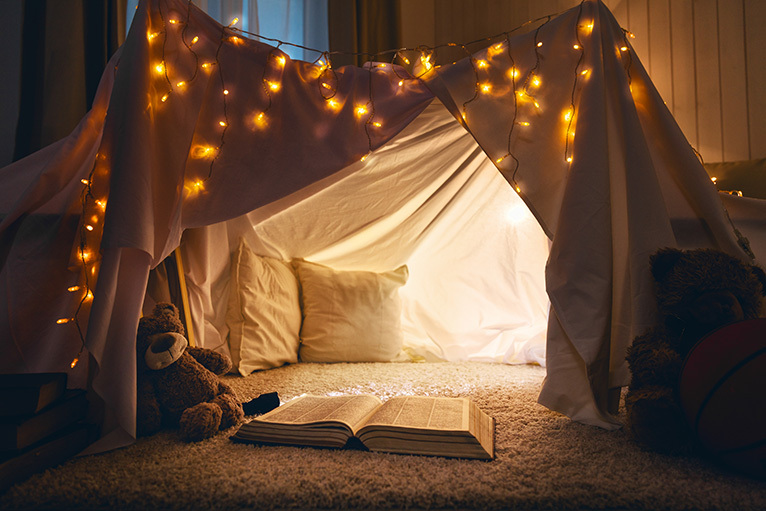 Kids tent made with bedsheets in a cosy living room