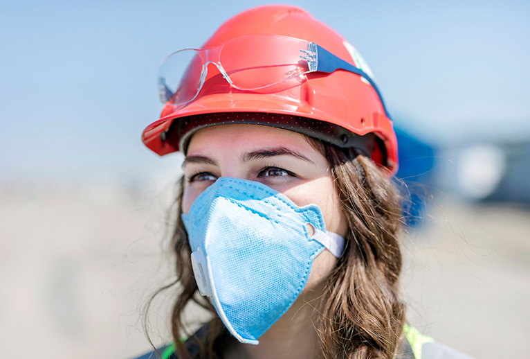 Coronavirus: Woman in hard hat and mask