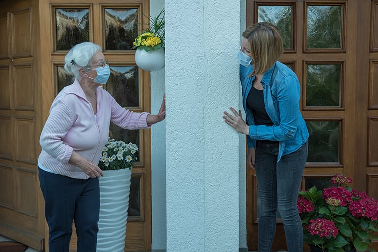 Neighbours wearing mask and talking