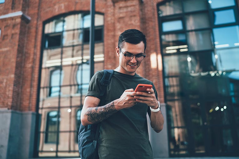 Person smiling at their smartphone
