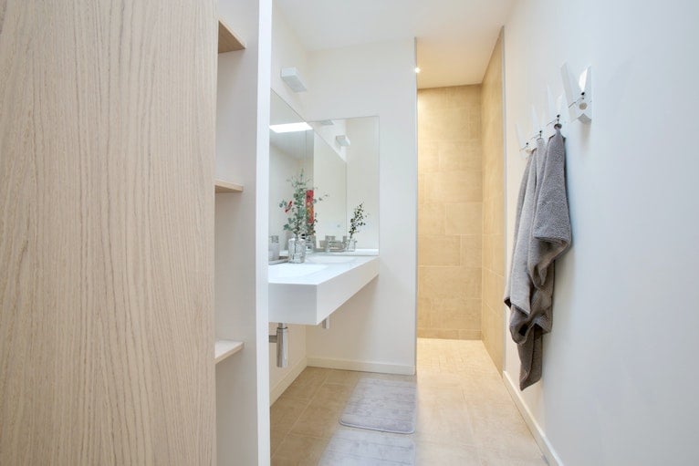 Peg-style bathroom wall hooks holding towels