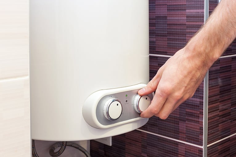 Person adjusting boiler temperature