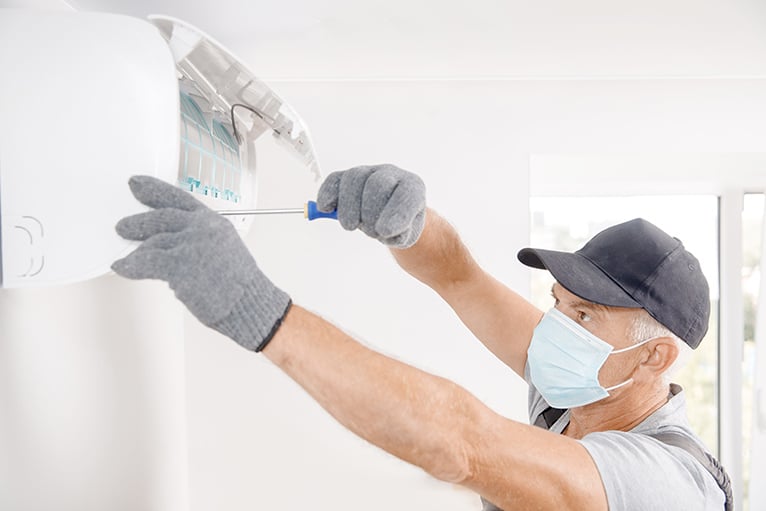 Technician doing a repair in a home
