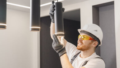 Electrician installing lighting inside home.