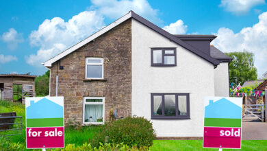 For Sale and Sold signs outside semi detached houses