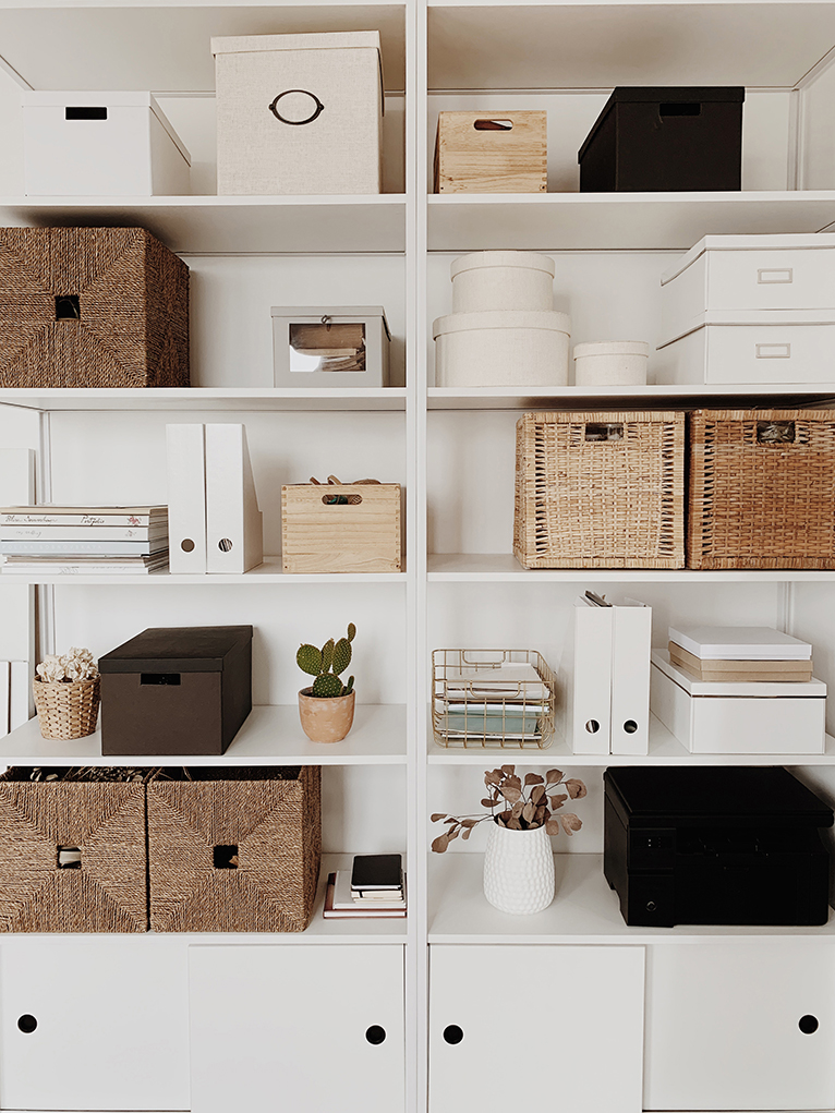 Home office cabinet with rattan boxes, plants and letter trays
