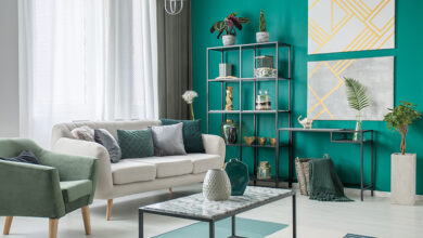 Modern living room with green feature wall and contemporary furniture.