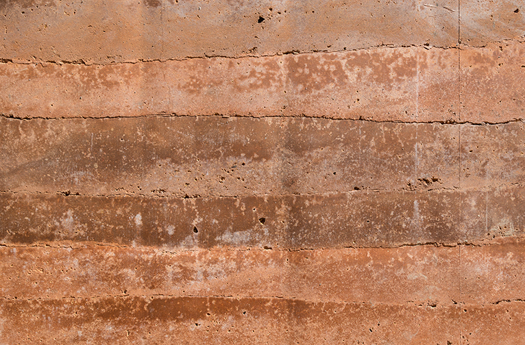 Close up of an eco-friendly, sustainable rammed earth wall.