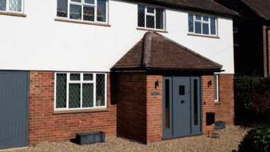 Black door on brick porch