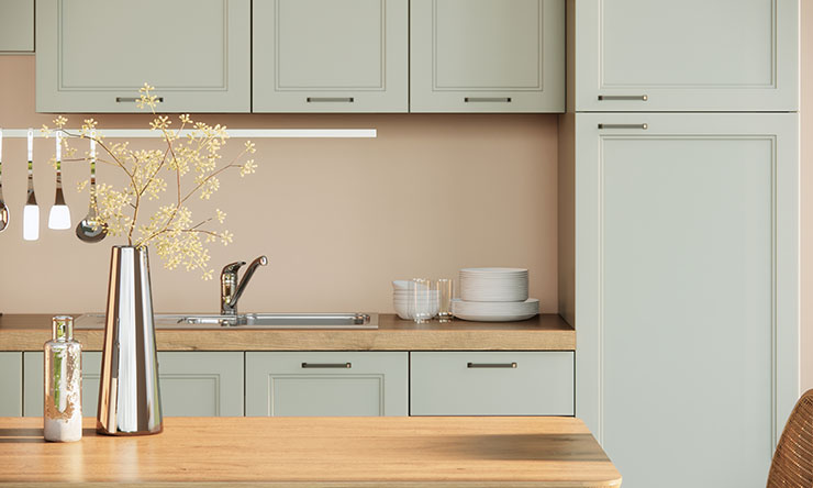 Image of a modern Japandi decor, simple kitchen design using wooden tabletops and pastel green cabinets