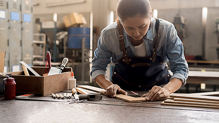Photo of an Asian women carpenter in a workshop