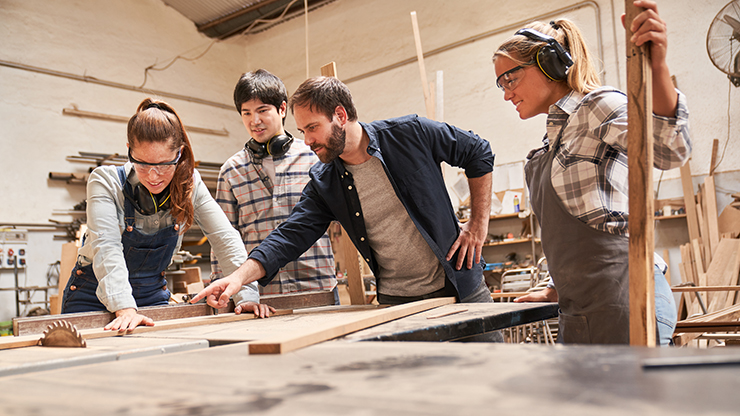 Photo of apprentices in a workshop doing woodwork