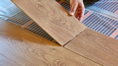 Picture of a person installing underfloor heating and laminate flooring