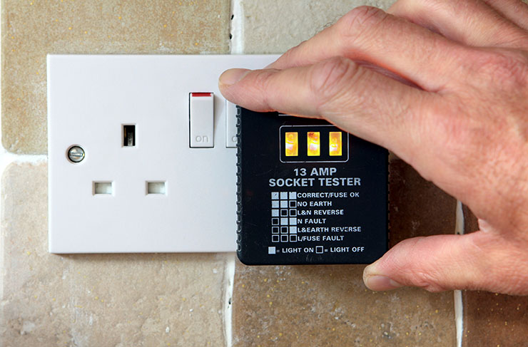 Picture of a socket with a 13 AMP tester