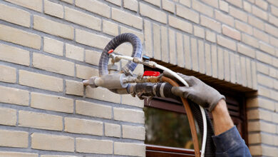 Picture of cavity wall insulation being installed by a tradesperson
