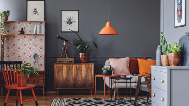 Picture of a living room with geometric patterned carpet and orange furniture