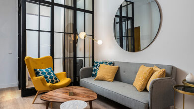 Oicture of a living room with a large round mirror