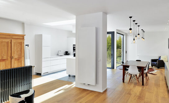 Picture of a living room with large radiator against wall