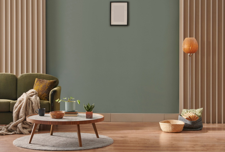 Picture of a living room with a low wooden coffee table and grey walls