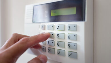 Picture of a hand pressing button on a burglar alarm keypad