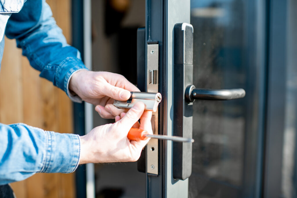 Picture of a tradesperson replacing a door lock