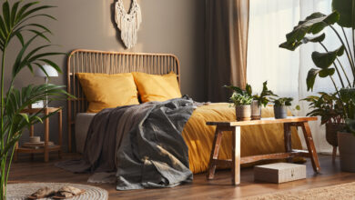 Picture of a bedroom with plants and orange sheets