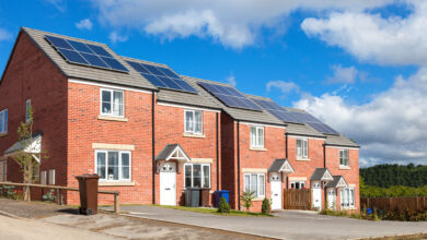 Picture of a row of houses with solar panels on a cloudy day