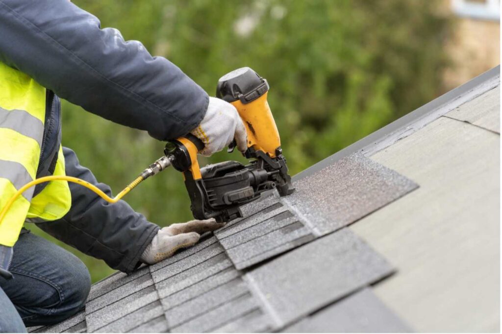 Picture of a roof specialist installing roof tiles to a roof