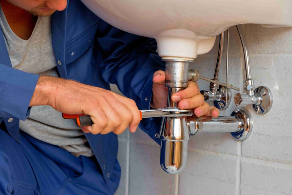 Picture of a plumber installing a bathroom sink