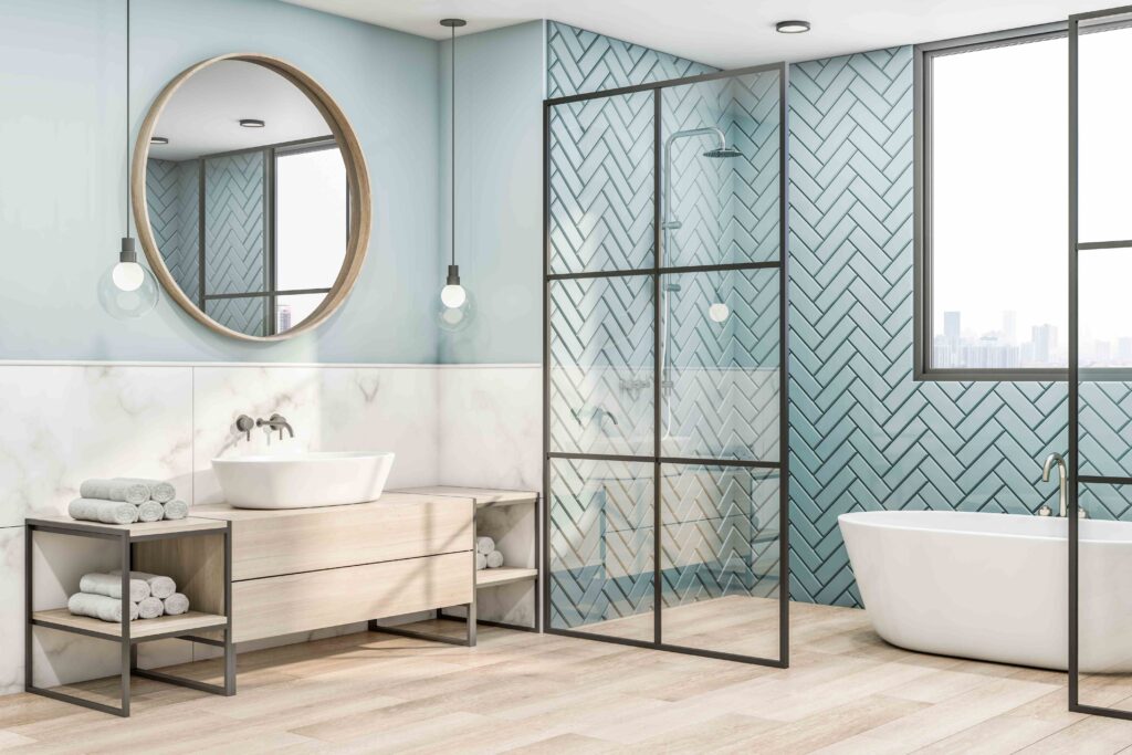 Picture of a modern, light blue bathroom with blue bathroom tiles and wooden floors