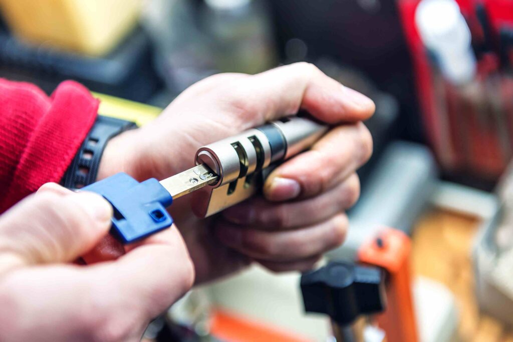 Picture of a locksmith testing a key with a door lock cylinder