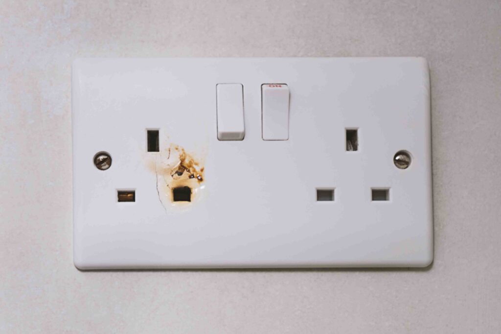 Picture of a UK socket with brown scorch marks