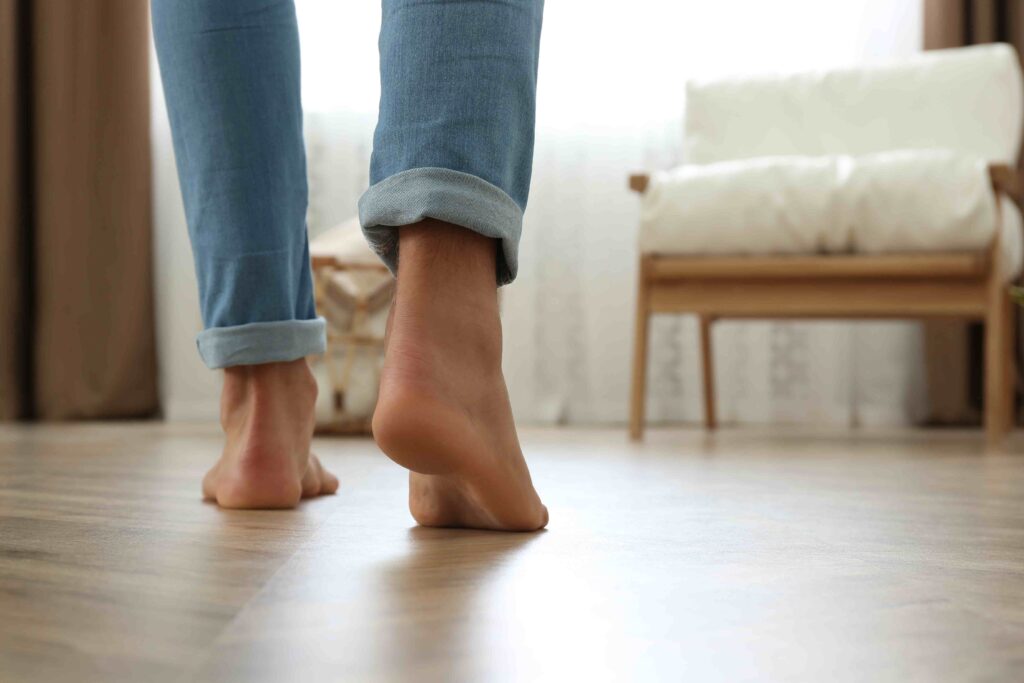 Picture of a man walking barefoot on wooden floors with underfloor heating underneath